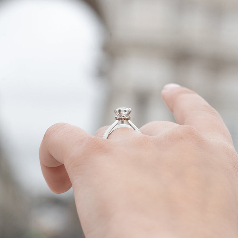 side angle of diamond platinum engagement ring on finger