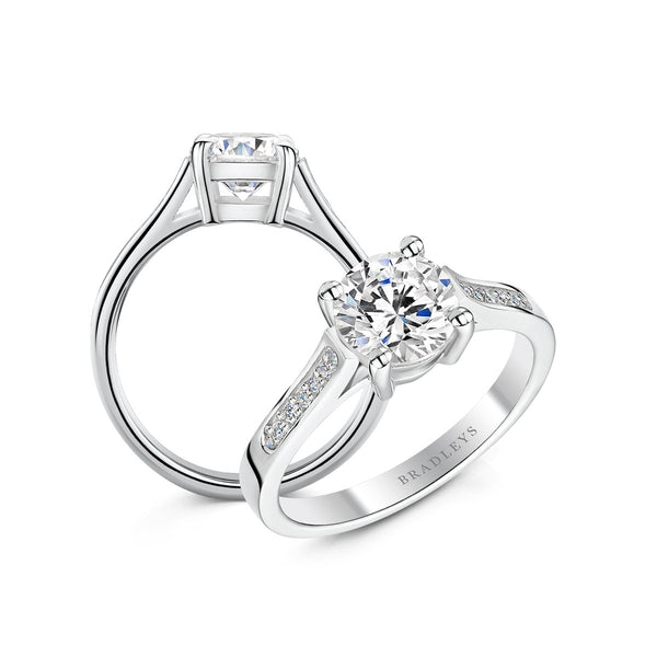 two angles of silver coloured diamond engagement ring