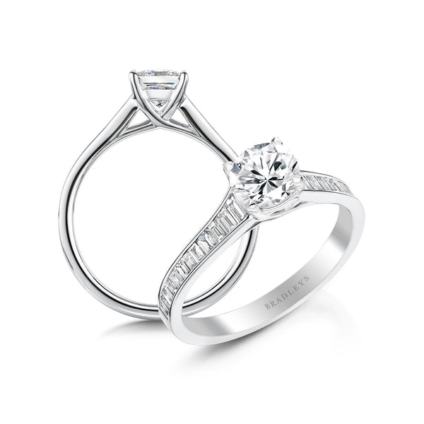 round brilliant cut engagement ring  with elegant baguette cut diamond shoulders
