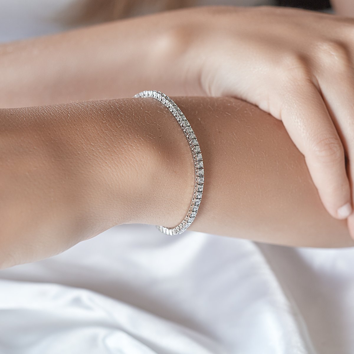 lady wearing diamond white gold tennis bracelet